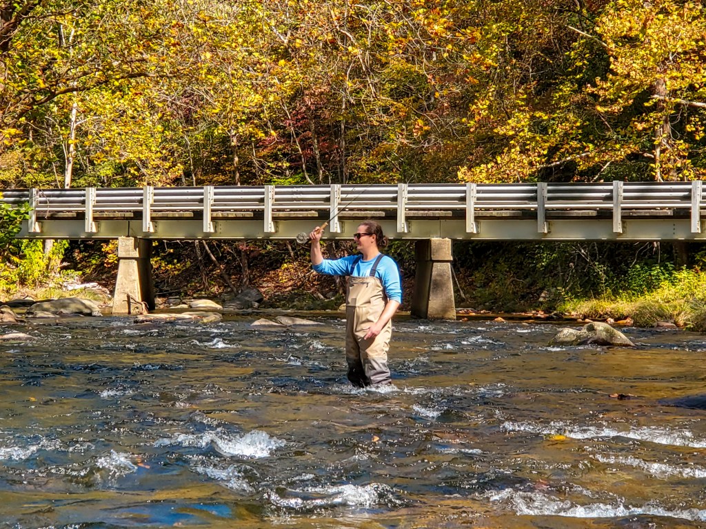A man casts while fly fishing on the Upper Nantahala river in North Carolina.
