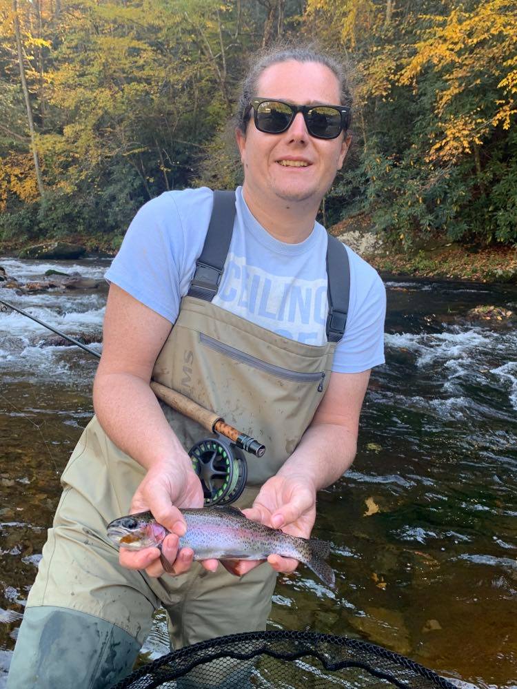 Parker holds a rainbow trout caught while fly fishing in Western North Carolina.